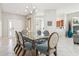 Dining room with a glass-top table and six light-blue chairs at 305 Therese St, Davenport, FL 33897