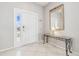 Bright entryway with a white door, a console table, and a large mirror at 305 Therese St, Davenport, FL 33897
