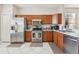 Kitchen with stainless steel appliances and wood cabinets at 305 Therese St, Davenport, FL 33897