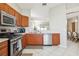 Kitchen with stainless steel appliances and wood cabinets at 305 Therese St, Davenport, FL 33897