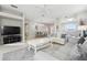 Living room with gray sofas, a coffee table, and views into dining area at 305 Therese St, Davenport, FL 33897