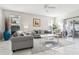 Spacious living room with gray sofas, a coffee table, and large windows at 305 Therese St, Davenport, FL 33897