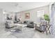 Spacious living room with gray sofas, a coffee table, and large windows at 305 Therese St, Davenport, FL 33897