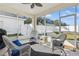 Relaxing screened patio with wicker furniture and ample seating at 305 Therese St, Davenport, FL 33897