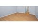 Bedroom with wood-look floors and view of bathroom at 4172 Versailles Dr # 4172D, Orlando, FL 32808