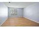 Simple bedroom with light walls, wood-look floors and window at 4172 Versailles Dr # 4172D, Orlando, FL 32808