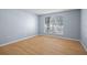 Bright bedroom with light walls, wood-look floors, and large window at 4172 Versailles Dr # 4172D, Orlando, FL 32808