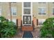 Condo building entrance with stairs and landscaping at 4172 Versailles Dr # 4172D, Orlando, FL 32808