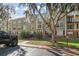 Exterior view of a condo building with landscaping and parking at 4172 Versailles Dr # 4172D, Orlando, FL 32808