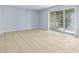 Living room with tile floors and balcony access at 4172 Versailles Dr # 4172D, Orlando, FL 32808