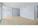 Living area with tile floors and access to other rooms at 4172 Versailles Dr # 4172D, Orlando, FL 32808