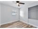 Bedroom with wood floors, ceiling fan and built-in closet at 4403 Brooke St, Orlando, FL 32811