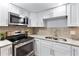 Newly remodeled kitchen with stainless steel appliances and granite countertops at 4403 Brooke St, Orlando, FL 32811