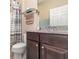 Clean bathroom with dark brown vanity and shower at 672 Cordoba Dr, Davenport, FL 33837