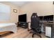 Bedroom with a bed, large TV, and a workspace setup at 672 Cordoba Dr, Davenport, FL 33837