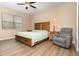 Bright bedroom with a queen-size bed, wood flooring, and ceiling fan at 672 Cordoba Dr, Davenport, FL 33837