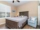 Bedroom with queen-size bed and light blue accent chair at 672 Cordoba Dr, Davenport, FL 33837