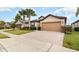 Two-story house with a two-car garage and a manicured lawn at 672 Cordoba Dr, Davenport, FL 33837