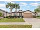 Single-Gathering home with a two-car garage and landscaped front yard at 672 Cordoba Dr, Davenport, FL 33837