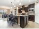Spacious kitchen with island, stainless steel appliances, and dark wood cabinets at 672 Cordoba Dr, Davenport, FL 33837