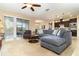 Open living room with sectional sofa, access to a patio, and view of kitchen at 672 Cordoba Dr, Davenport, FL 33837
