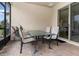 Covered patio with glass table and chairs, perfect for outdoor dining at 672 Cordoba Dr, Davenport, FL 33837