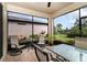 Screened patio with table and chairs; overlooks backyard at 672 Cordoba Dr, Davenport, FL 33837