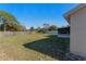 Large backyard with grassy lawn, screened porch, and wooden fence at 762 S Edgemon Ave, Winter Springs, FL 32708