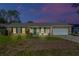 Brick ranch house with a two-car garage and well-maintained lawn at 762 S Edgemon Ave, Winter Springs, FL 32708