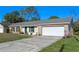 Brick ranch house with a one-car garage and green shutters at 762 S Edgemon Ave, Winter Springs, FL 32708