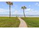 Walkway to the beach with palm trees and ocean view at 815 Ocean Shore Blvd # U9A, Ormond Beach, FL 32176