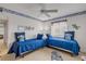 Guest bedroom with twin beds and ceiling fan at 815 Ocean Shore Blvd # U9A, Ormond Beach, FL 32176