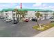 Front view of condo building, showing parking and landscaping at 815 Ocean Shore Blvd # U9A, Ormond Beach, FL 32176