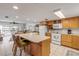 Kitchen with island, white appliances, and wood cabinets at 815 Ocean Shore Blvd # U9A, Ormond Beach, FL 32176