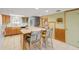 L-shaped kitchen with an island and light wood cabinets at 815 Ocean Shore Blvd # U9A, Ormond Beach, FL 32176