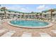 Circular pool with surrounding lounge chairs and patio at 815 Ocean Shore Blvd # U9A, Ormond Beach, FL 32176