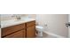 Well-lit bathroom features a modern vanity with a neutral countertop and wooden cabinets at 9025 Savannah Julip Ln, Orlando, FL 32832