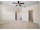 Spacious carpeted bedroom with ceiling fan, with multiple closets and doorways at 9025 Savannah Julip Ln, Orlando, FL 32832