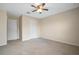 A cozy bedroom featuring neutral walls, plush carpeting, and a closet at 9025 Savannah Julip Ln, Orlando, FL 32832
