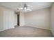 A cozy bedroom featuring neutral walls, plush carpeting, and a modern ceiling fan with lighting at 9025 Savannah Julip Ln, Orlando, FL 32832