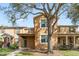 Charming townhouse featuring a well-maintained lawn and inviting front entryway at 9025 Savannah Julip Ln, Orlando, FL 32832