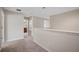 Hallway featuring neutral walls, plush carpeting, a decorative wall, and views to bathroom and loft at 9025 Savannah Julip Ln, Orlando, FL 32832