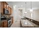 Beautiful kitchen with granite countertops, stainless appliances, and a breakfast bar at 9025 Savannah Julip Ln, Orlando, FL 32832