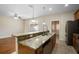 Spacious kitchen with a breakfast bar, stainless steel appliances, and hardwood floors at 9025 Savannah Julip Ln, Orlando, FL 32832