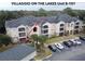Aerial view of condo building, showing unit location and parking at 940 Village Trl # 8-101, Port Orange, FL 32127
