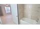 Clean bathroom with a bathtub, shower, and updated vanity at 940 Village Trl # 8-101, Port Orange, FL 32127