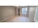 Bright bedroom with ceiling fan, window blinds, and walk-in closet at 940 Village Trl # 8-101, Port Orange, FL 32127