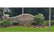 Community entrance sign for Villaggio on the Lakes with landscaping at 940 Village Trl # 8-101, Port Orange, FL 32127