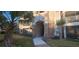 Exterior view of building entrance with stone accents and landscaping at 940 Village Trl # 8-101, Port Orange, FL 32127