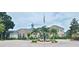 Grand entrance to the community with a fountain and flagpole at 940 Village Trl # 8-101, Port Orange, FL 32127